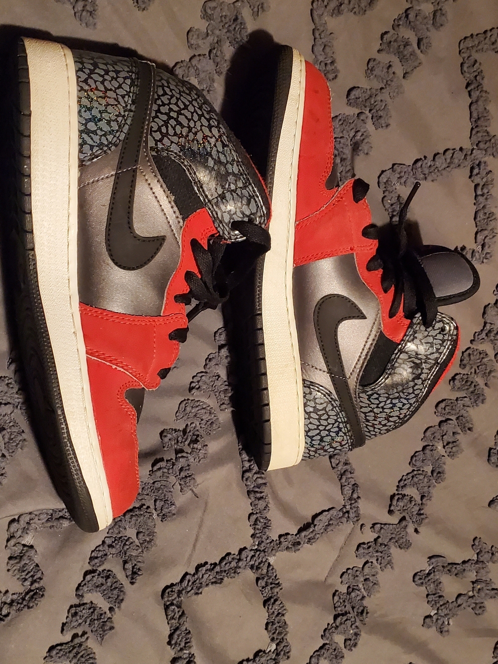 Nike Air Jordan 1 Mid GS sneakers in a "Black / University Red / Lt Smoke